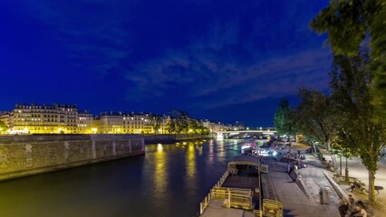 Wall Mural - View to the Pont De La Tournelle on the River Seine day to night transition timelapse with waterfront from Bridge of the Archbishopric. Numerous such boats ply the Seine each day, passing many famous