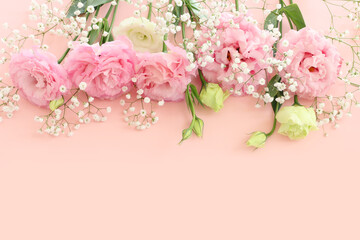 Wall Mural - Top view image of delicate pink flowers over pastel background