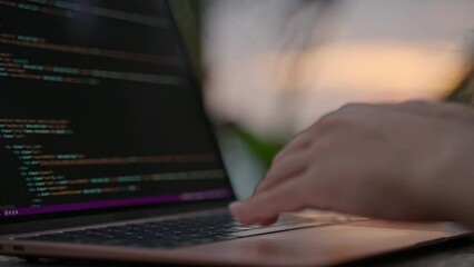 Female developer working on laptop by the ocean. Young woman freelancer coding at outdoor tropical cafe. Caucasian girl working remotely typing on computer at exotic location close-up. Worldwide work.