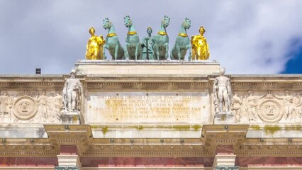 Wall Mural - Triumphal Arch (Arc de Triomphe du Carrousel) timelapse hyperlapse at Tuileries gardens in Paris, France. Tourist walking around at summer day with blue cloudy sky. Walking toward