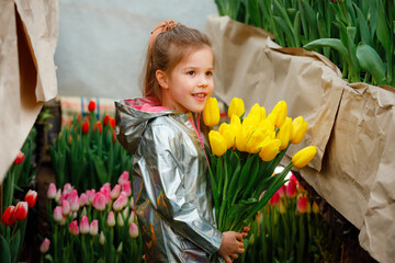 Portrait of a girl with tulips in spring. Children's dentistry. Garden at home