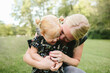 © Maria Manco/Stocksy - Mom hugs daughter close