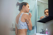 © EASY 2 SHOOT/Stocksy - Woman in bathroom morning beauty routine