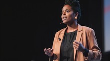 A Fictional Person. Black Female Speaker Delivering An Inspiring Presentation At A Business Conference