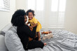 © Alison Winterroth/Stocksy - Girl with huge smile as mom kisses her
