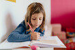 © Albert Martinez/Stocksy - Girl doing homework