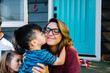 © Maria Manco/Stocksy - Child give mom a kiss on the cheek outside