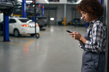 Wall Mural - Multiracial employee presses on the buttons of a mobile phone