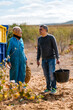 © Ezequiel Giménez/Stocksy - Happy aged man with son smiling in countryside