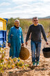 © Ezequiel Giménez/Stocksy - Happy senior man with son working together in vineyard
