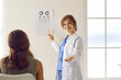 © Studio Romantic - Positive Caucasian female optician in white medical uniform tests vision using Optometry table in optics salon. Smiling woman doctor in private clinic or hospital. Eyesight correction.