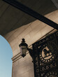 © Andrew Urwin/Stocksy - Cast iron metal gates and lamp on marble arch