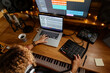 © Jimena Roquero/Stocksy - Music engineer working at home studio using midi pad controller