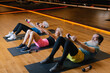 © Oleksii Syrotkin/Stocksy - Collective training. Retired couple. Professional coach. Gym hall