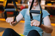 © Oleksii Syrotkin/Stocksy - Suspension trainers. Gym interior. Focus. Sport tool. Concentration