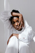 © Tania Cervian/Stocksy - Calm young black woman touching face in sunlight