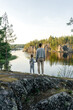 © Sergey Narevskih/Stocksy - Woman and child standing on hill against calm lake