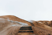 Wooden Stairs Leading Up Along Brown Landscape Of Iceland 