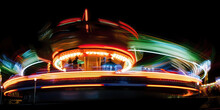 An Amusement Part Ride In Motion At Night By Generative AI