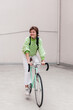 © Viktor Solomin/Stocksy - Smiling girl riding bicycle on street