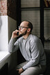 © Oleksii Syrotkin/Stocksy - Smartphone call indoor gadget serious