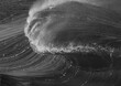 © James Fulton/Stocksy - Close up of wave breaking in black and white