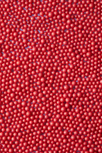 Bright Background With Small Red Spheres.
