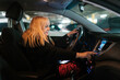 © Ezequiel Giménez/Stocksy - Woman sitting on driver seat in car