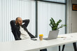 © Danil Nevsky/Stocksy - Male employee watching video on laptop in office