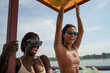 © Jovo Jovanovic/Stocksy - Female friends in bikini laughing on boat sailing in sea