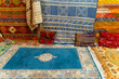 © Mauro Grigollo/Stocksy - Carpets on sale in a Moroccan shop