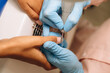 © Alina Hvostikova/Stocksy - Master polishing nails of client in salon