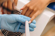 © Alina Hvostikova/Stocksy - Master polishing nails of client in salon
