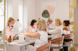 © Alina Hvostikova/Stocksy - Professional manicurists giving manicure to clients