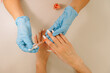 © Alina Hvostikova/Stocksy - Crop manicurist applying nail serum on fingernail