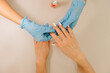 © Alina Hvostikova/Stocksy - Crop manicurist applying nail serum on fingernail