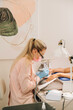 © Alina Hvostikova/Stocksy - Master doing manicure in nail bar