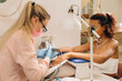 © Alina Hvostikova/Stocksy - Master doing manicure in nail bar