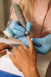© Alina Hvostikova/Stocksy - Manicurist with milling cutter for manicure