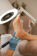 © Alina Hvostikova/Stocksy - Crop pedicurist polishing heel with machine