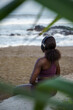 © Jovo Jovanovic/Stocksy - Back view of woman wearing headphones enjoying the beach view