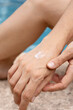 © María Soledad Kubat/Stocksy - Young Woman Putting Lotion On Her hands
