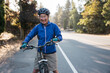 © Rob and Julia Campbell/Stocksy - Woman riding her bike in bike lane in the morning.