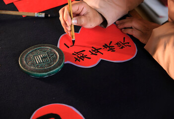 Make traditional Chinese New Year brush calligraphy decorations