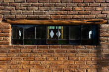 An Old Brick Wall With A Retro Window