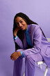 © Javier Díez/Stocksy - Stylish woman sitting on chair