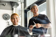 © Dylan Leeder/Stocksy - Barber And Client Laugh Together