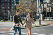 © Daniel Gonzalez/Stocksy - Happy loving couple holding hands and crossing road