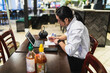 © Diego Martin/Stocksy - Asian man working in a restaurant
