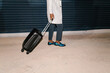 © Ezequiel Giménez/Stocksy - Crop black man with luggage on street